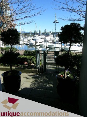 Furnished living room with a stunning city view and marina, perfect for relaxation. - TH 120 - 1228 Marinaside Crescent, Vancouver Downtown