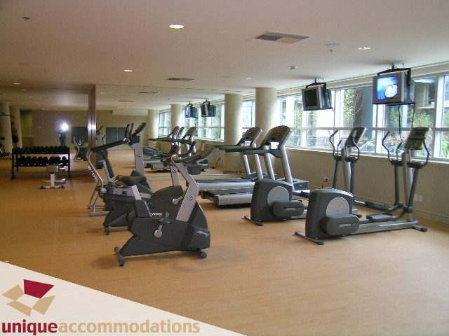 Bright and spacious gym with cardio equipment and large windows, offering a city view. - 1805 - 428 Beach Crescent, Vancouver Downtown