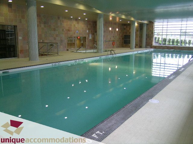 Spacious indoor pool with tiled walls and floor, natural light from large windows. - 1805 - 428 Beach Crescent, Vancouver Downtown