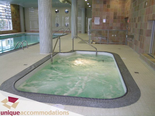 Spacious indoor pool with tiled floors and water jets. - 1805 - 428 Beach Crescent, Vancouver Downtown