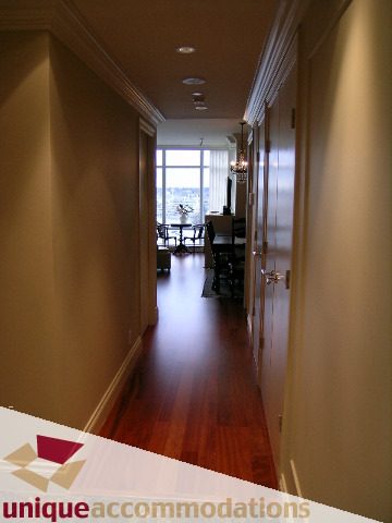 Furnished hallway leading to living area with hardwood floors and city view. - 1805 - 428 Beach Crescent, Vancouver Downtown