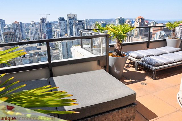 Spacious balcony with lounge chairs and city view, perfect for relaxation. - PH1 - 969 Richards Street, Vancouver Downtown
