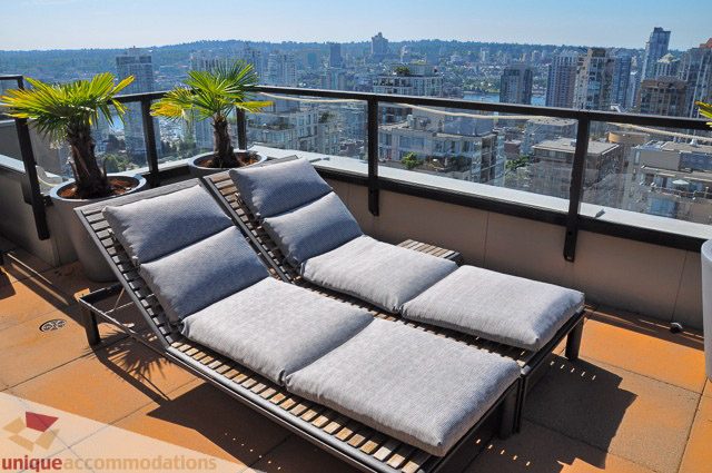 Furnished balcony with lounge chairs and city view, perfect for relaxation. - PH1 - 969 Richards Street, Vancouver Downtown