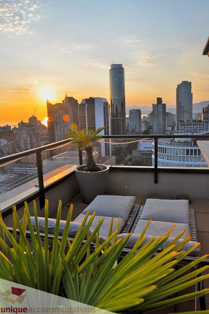 Spacious PH1 balcony with lounge chairs, city view, and sunset glow. - PH1 - 969 Richards Street, Vancouver Downtown