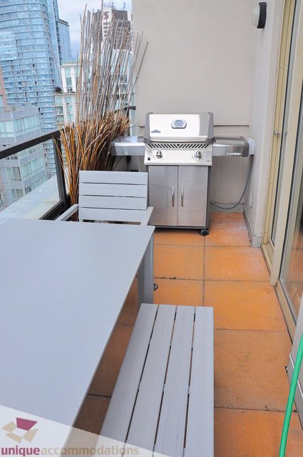 Furnished patio with a grill, outdoor seating, and city view. - PH1 - 969 Richards Street, Vancouver Downtown