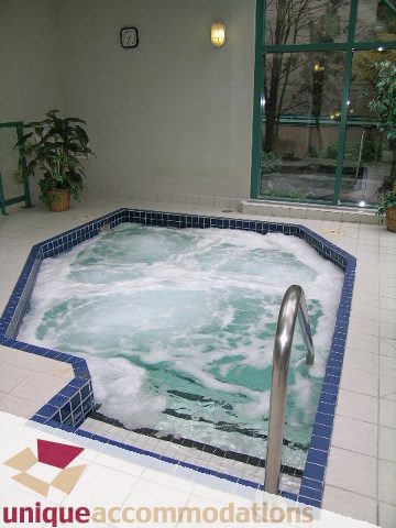 Jacuzzi with bubbling water and tiled edges. - 945 Homer Street, Vancouver Downtown
