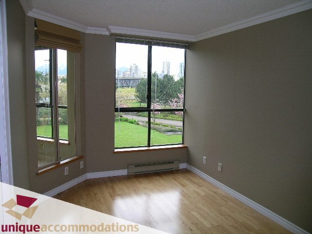 Bright living room with hardwood floors and city view. - 105 - 1490 Pennyfarthing, Vancouver West Side