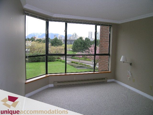 Den with large bay window offering city view and greenery. - 105 - 1490 Pennyfarthing, Vancouver West Side