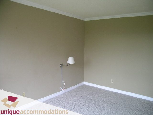 Den with carpeted floor and wall-mounted lamp. - 105 - 1490 Pennyfarthing, Vancouver West Side