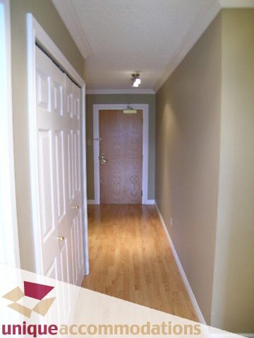 Bright hallway with wooden floors and white trim. - 105 - 1490 Pennyfarthing, Vancouver West Side