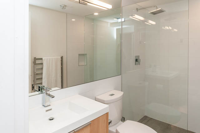 Furnished bathroom with modern sink, glass shower, and large mirror. - 1503 - 198 Aquarius Mews, Vancouver Downtown