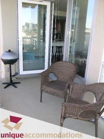 Bright balcony with city view, wicker furniture, and modern decor. - 411 - 2055 Yukon Street, Vancouver West Side