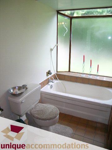 Bright bathroom with large window, modern fixtures, and white bathtub. - 94 Bonnymuir Drive, West Vancouver