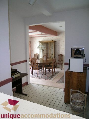Furnished dining area with wooden chairs and checkered floor. - 94 Bonnymuir Drive, West Vancouver