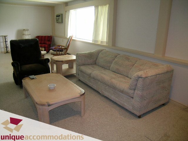 Living room with large sectional sofa, coffee table, and recliner. - 94 Bonnymuir Drive, West Vancouver