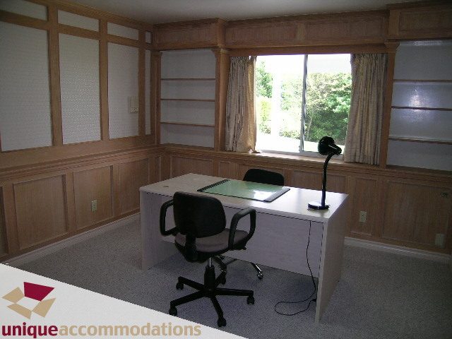 Bright study with built-in shelves, large window, and desk setup. - 94 Bonnymuir Drive, West Vancouver