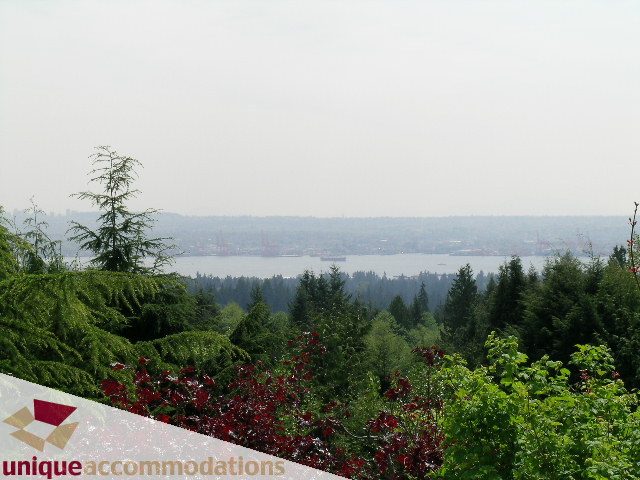 Spacious living room with a stunning city view and lush greenery. - 94 Bonnymuir Drive, West Vancouver