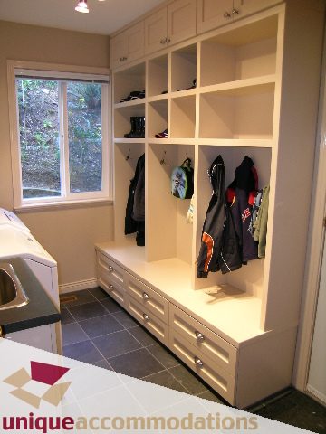 Walk-in closet with built-in shelves and drawers, countertop, window view. - 1003 Kilmer Road, North Vancouver