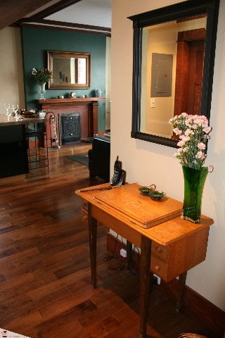 Bright living room with hardwood floors, a fireplace, and a wooden desk with a vase of flowers. - 30 - 777 Burrard Street, Vancouver Downtown