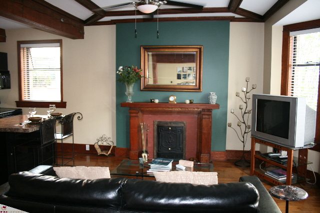 Living room with dark wood accents, modern furnishings, and a large window. - 30 - 777 Burrard Street, Vancouver Downtown