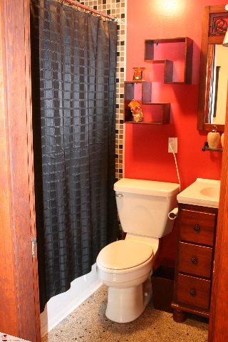 Small bathroom with red walls, black shower curtain, and wooden vanity. - 30 - 777 Burrard Street, Vancouver Downtown