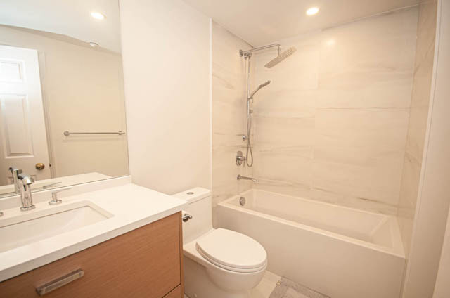Bright bathroom with white marble tiles and modern fixtures. - 1901 - 909 Burrard Street, Vancouver Downtown