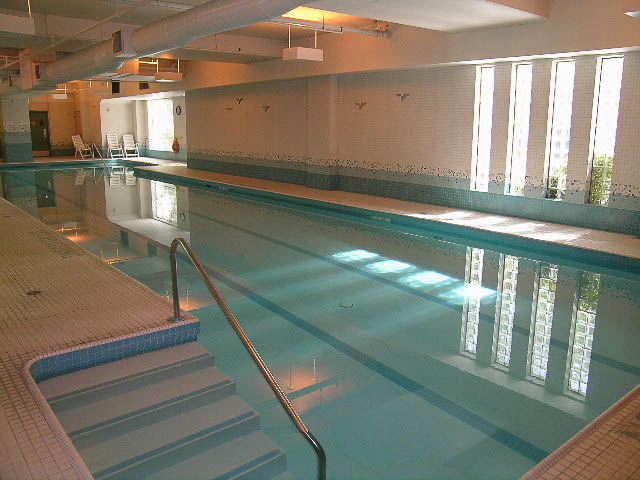 Spacious, well-lit indoor pool area with tiled walls and floor, modern design. - 1901 - 909 Burrard Street, Vancouver Downtown