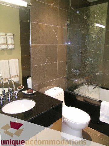 Modern bathroom with sleek countertop and large mirror, perfect for a cozy downtown condo. - 2401 - 1077 W. Cordova Street, Vancouver Downtown