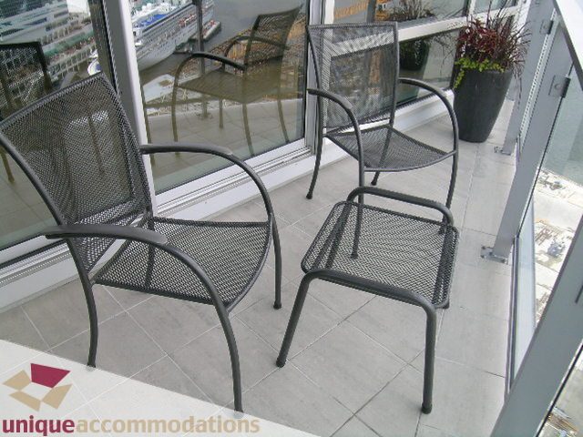 Furnished balcony with glass doors, city view, and comfortable seating. - 2401 - 1077 W. Cordova Street, Vancouver Downtown