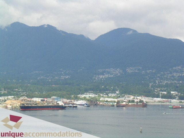 Panoramic view of Vancouver from the balcony, featuring mountains and boats in the harbor. - 2401 - 1077 W. Cordova Street, Vancouver Downtown