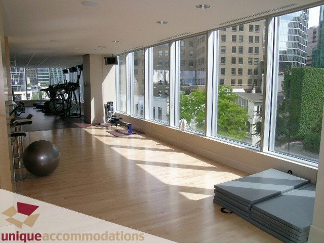 Spacious, well-lit fitness room with hardwood floors, city view, and exercise equipment. - 2401 - 1077 W. Cordova Street, Vancouver Downtown