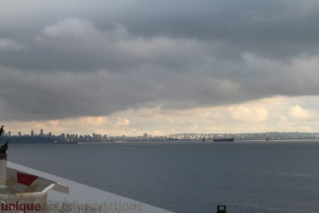 Furnished living room with city view and large windows. - 3906 Marine Drive, West Vancouver