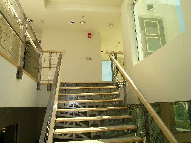 Staircase with modern railings and glass panels leading to upper levels. - 947 Huntingdon Crescent, North Vancouver