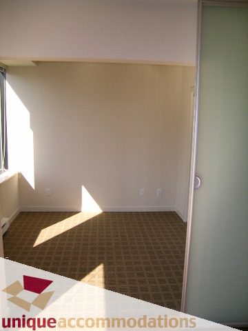 Bright den with carpeted floor and sliding door, natural light streaming in. - 1501 - 1333 West Georgia Street, Vancouver Downtown