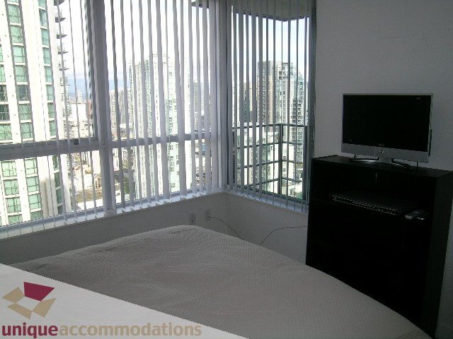Furnished 1-bedroom condo with large windows offering a city view. - 2707 - 1495 Richards Street, Vancouver Downtown