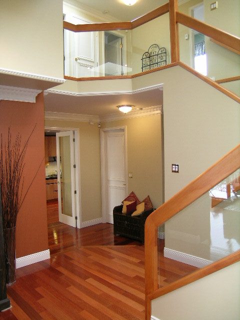 Staircase leading to upper level with hardwood floors and a cozy living area below. - 1233 11th Street, West Vancouver