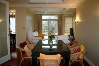 Furnished living room with hardwood floors and large windows, offering a cozy and inviting atmosphere. - 1233 11th Street, West Vancouver