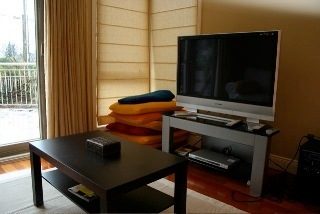 Living room with hardwood floors, modern furniture, and a view of the balcony. - 1233 11th Street, West Vancouver