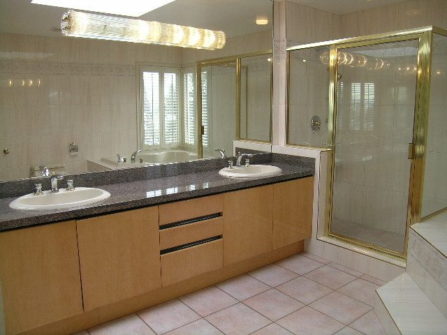 Spacious bathroom with granite countertops, double sinks, and a walk-in shower. - 1233 11th Street, West Vancouver