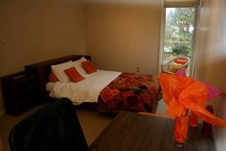 Furnished bedroom with cozy bedding and large window view. - 1233 11th Street, West Vancouver