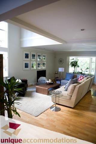 Spacious living room with hardwood floors, large windows, and comfortable seating. - 2555 W 2nd Avenue, Vancouver West Side