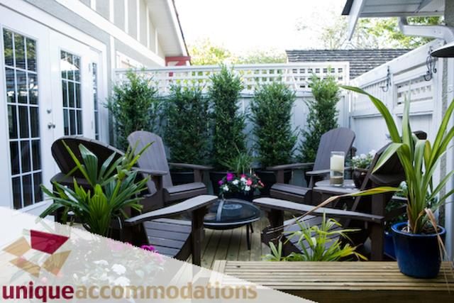 Furnished patio with Adirondack chairs and potted plants. - 2555 W 2nd Avenue, Vancouver West Side