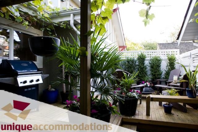 Furnished patio with outdoor seating, plants, and barbecue grill. - 2555 W 2nd Avenue, Vancouver West Side