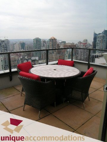 Furnished balcony with red cushioned chairs and city view. - PH2 - 969 Richards Street, Vancouver Downtown