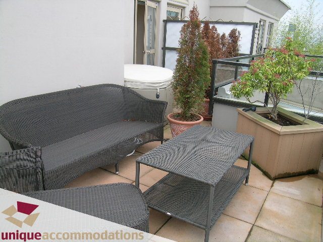 Furnished patio with wicker furniture and potted plants. - PH2 - 969 Richards Street, Vancouver Downtown