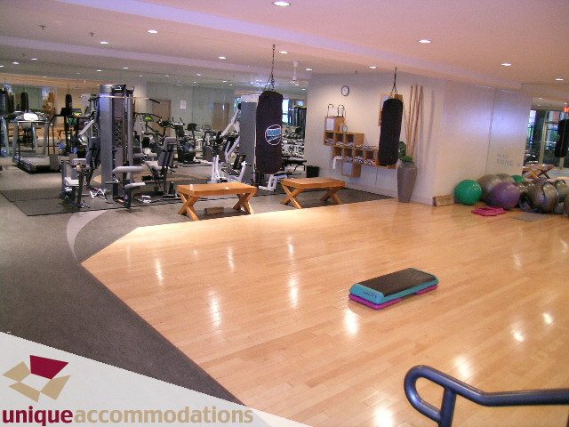 Bright gym with hardwood floors, exercise equipment, and mirrors. - PH2 - 969 Richards Street, Vancouver Downtown