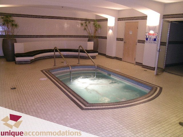 Spacious living room with large windows and cozy seating area. - PH2 - 969 Richards Street, Vancouver Downtown