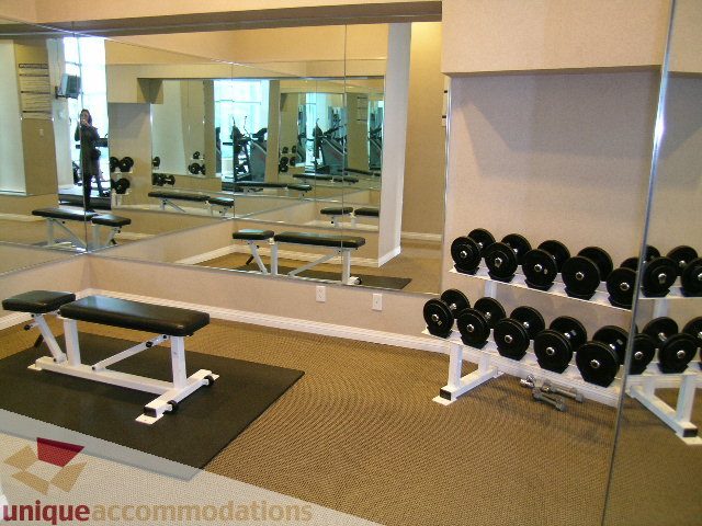 Furnished gym with weight benches and mirrors, perfect for fitness enthusiasts. - 603 - 1328 West Pender, Vancouver Downtown