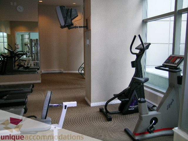 Spacious fitness room with cardio equipment and large windows. - 603 - 1328 West Pender, Vancouver Downtown