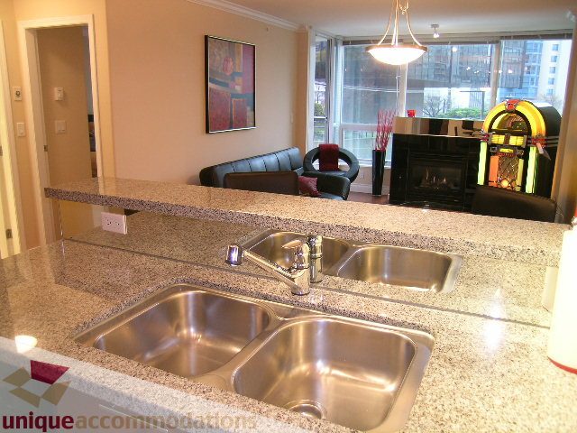 Modern kitchen with granite countertops, stainless steel sink, and city view. - 603 - 1328 West Pender, Vancouver Downtown